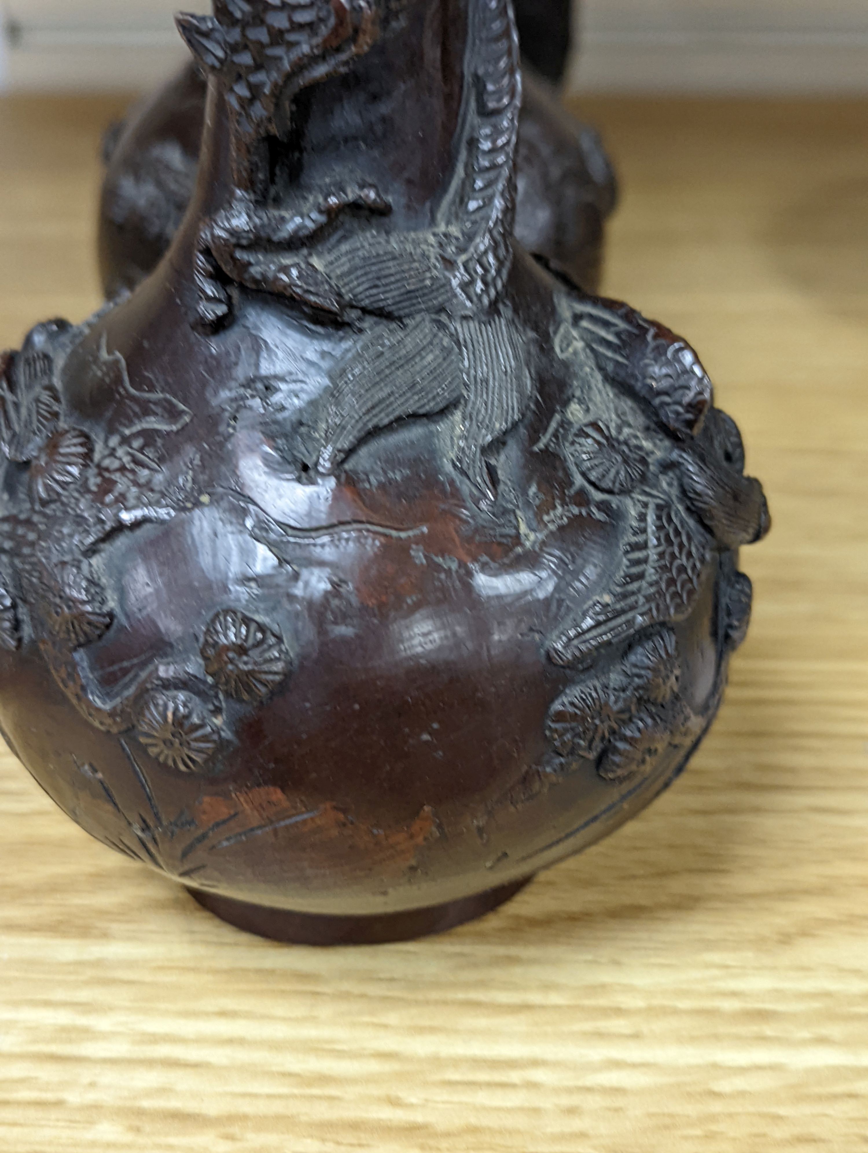 A pair of Japanese Meiji period bronze ‘dragon’ bottle vases and another, 21cm